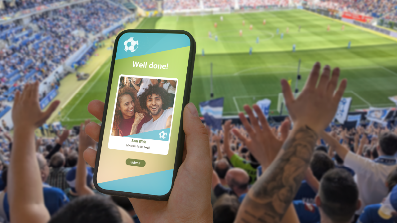A couple takes a selfie with the Virtual Photobooth at a stadium sports event