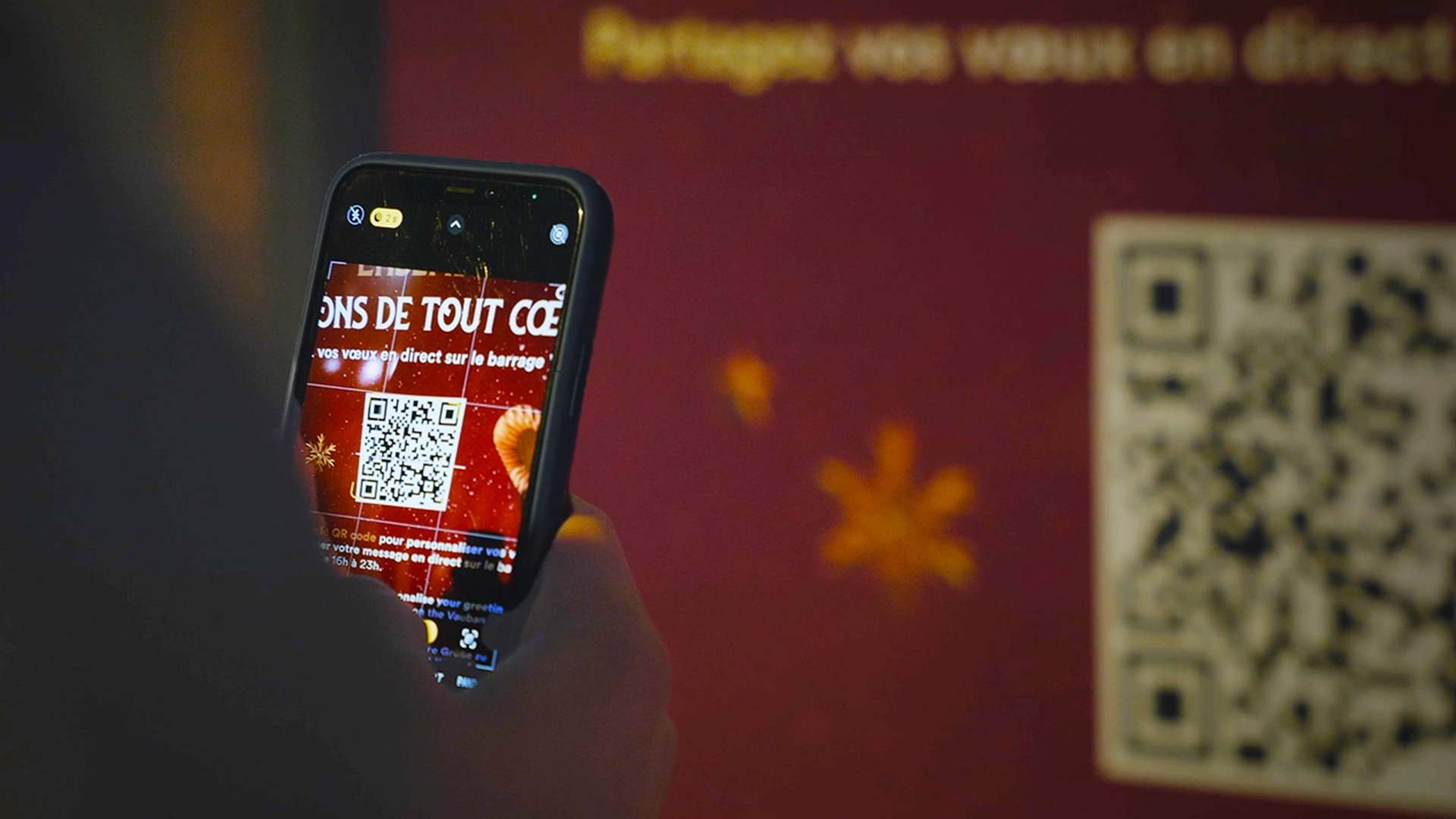 A participant flashes the QR code to open the interactive video mapping web application