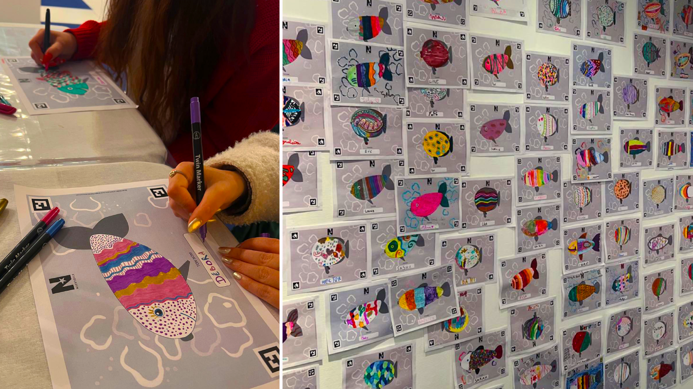 Deux personnes participent à une expérience de coloriage animé We Are Colors Ocean dans le centre commercial Nicetoile. Tous les dessins sont ensuite collés sur un mur.
