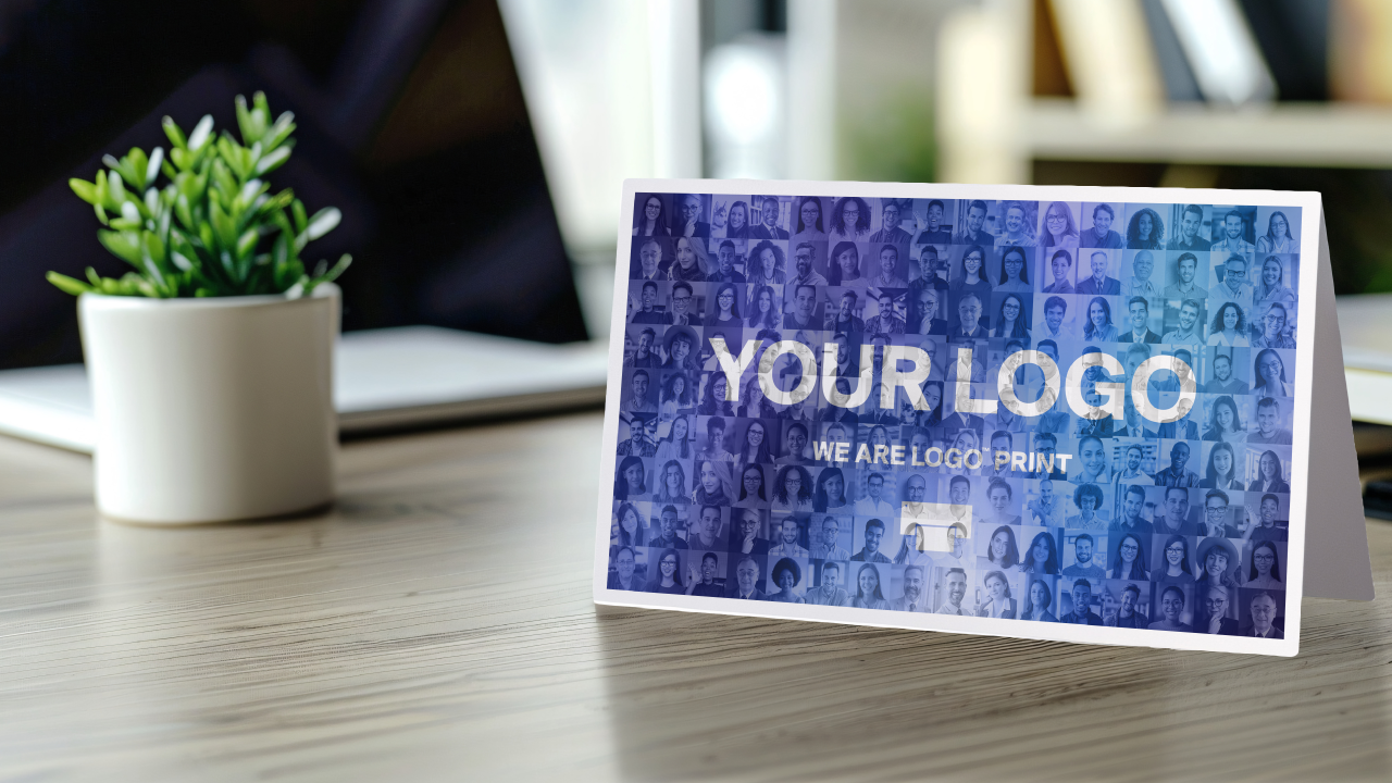 Photo mosaic printed on a paper card, placed on an office desk for corporate communication or gifts